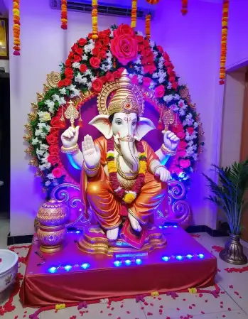 Ganesh Chaturthi decoration with illuminated Ganesha idol, flower backdrop, and colorful LED lights | Elegant Ganesh Chaturthi Flower Decoration with LED Lights | Ganesh Chaturthi | Decorations Guru